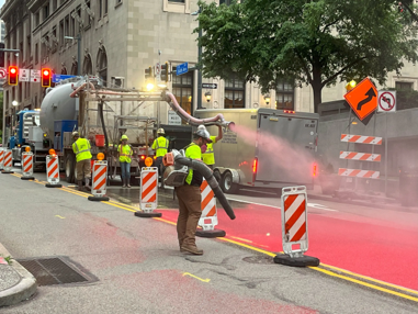Crews install the red bus lane on Sixth Avenue  in Downtown Pittsburgh last year.